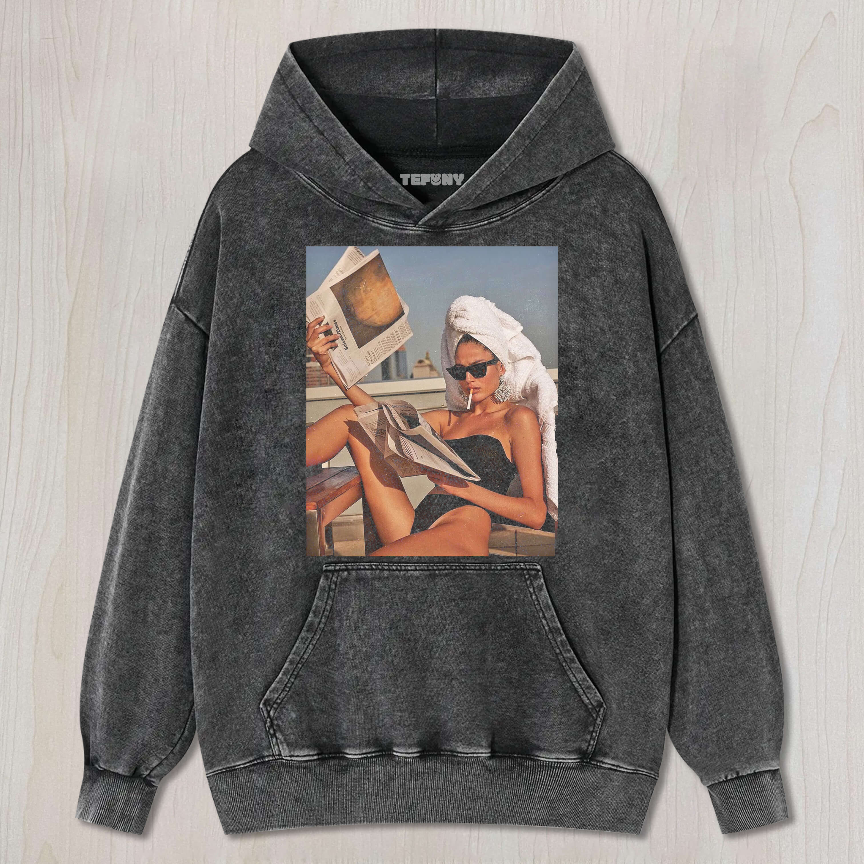 A BEAUTIFUL WOMAN READS A NEWSPAPER WHILE SUNBATHING T-SHIRT