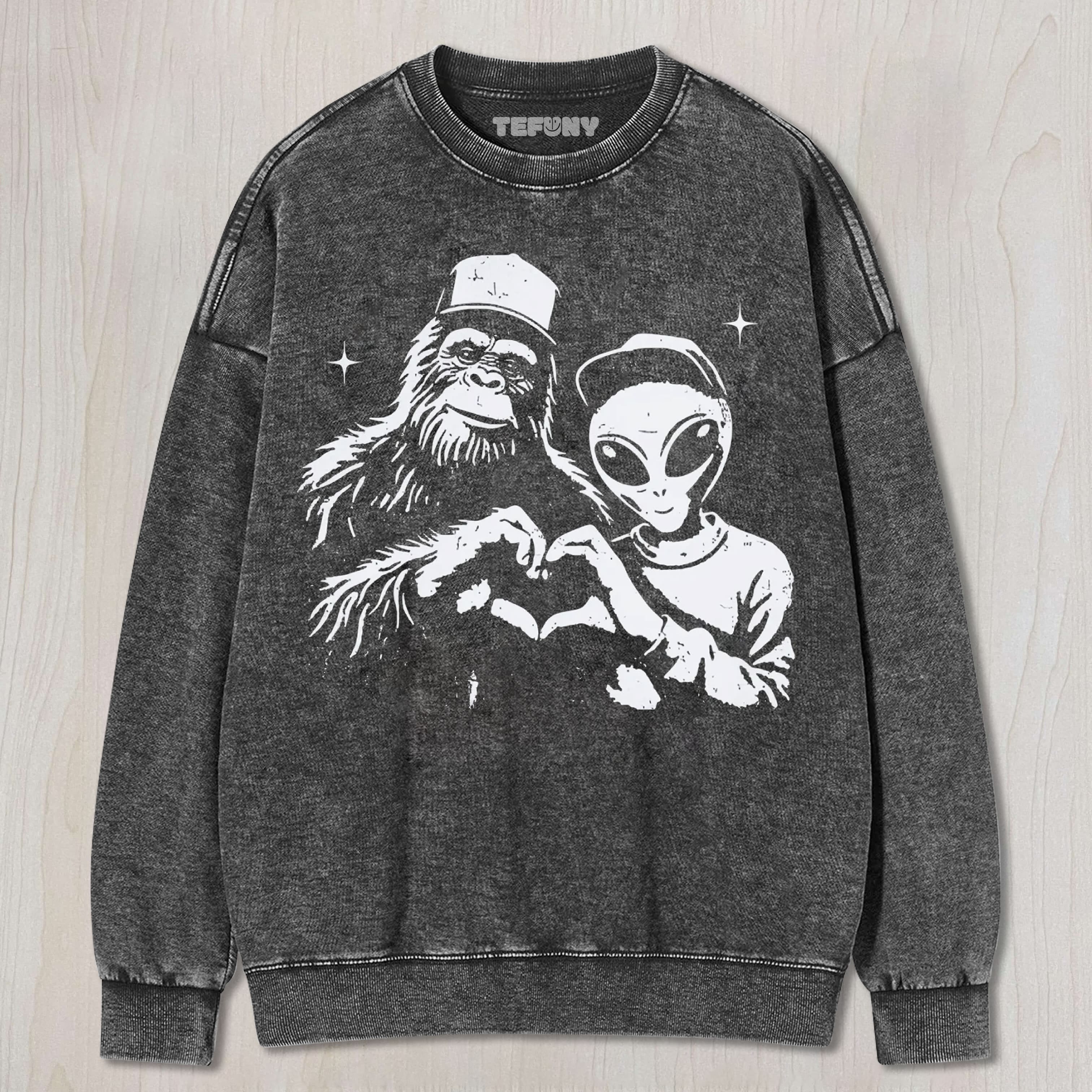 BIGFOOT AND ALIEN MAKING HEART GRAPHIC VINTAGE WASHED UNISEX TEE, TANK TOP, LAYERED LS, SWEATSHIRT & HOODIE