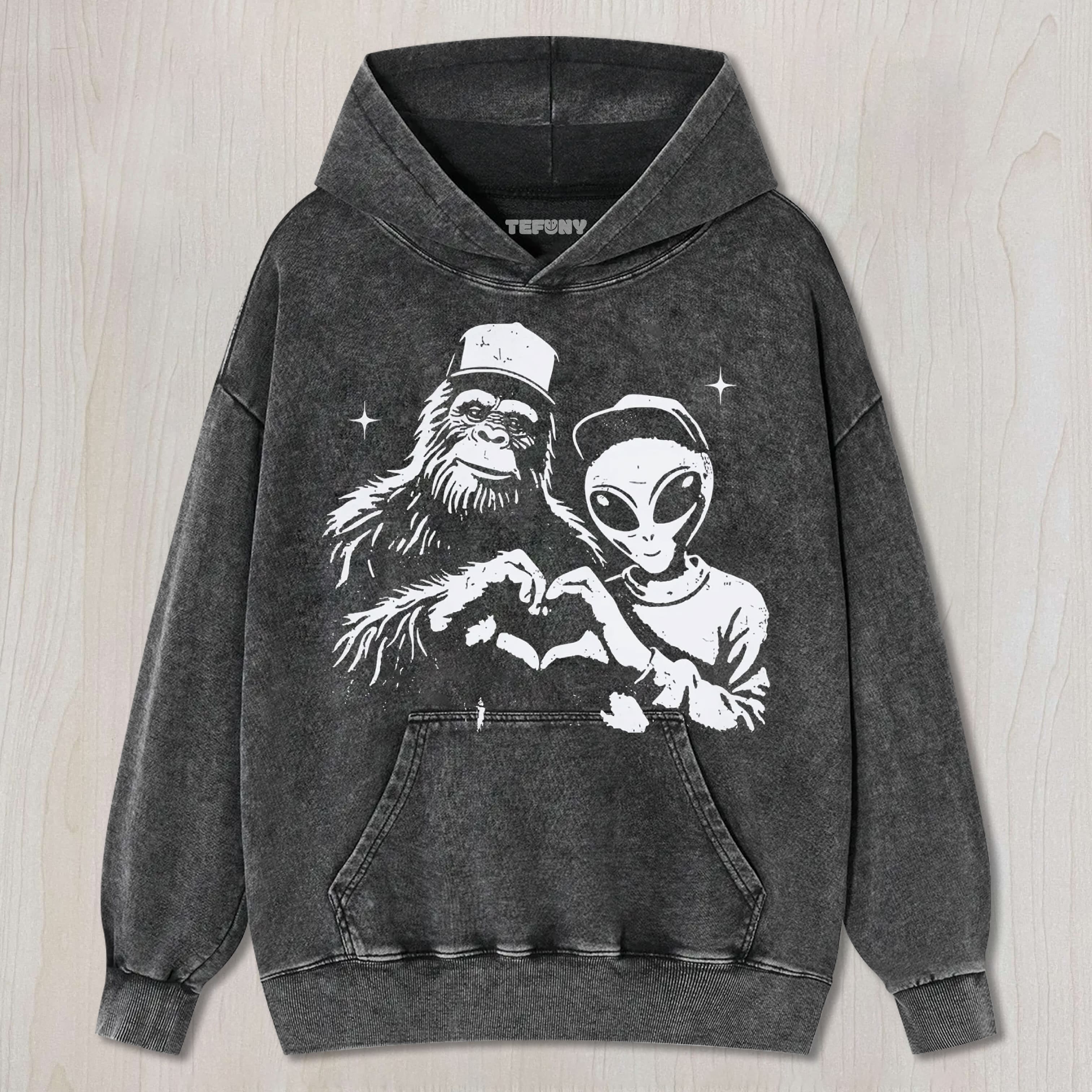 BIGFOOT AND ALIEN MAKING HEART GRAPHIC VINTAGE WASHED UNISEX TEE, TANK TOP, LAYERED LS, SWEATSHIRT & HOODIE