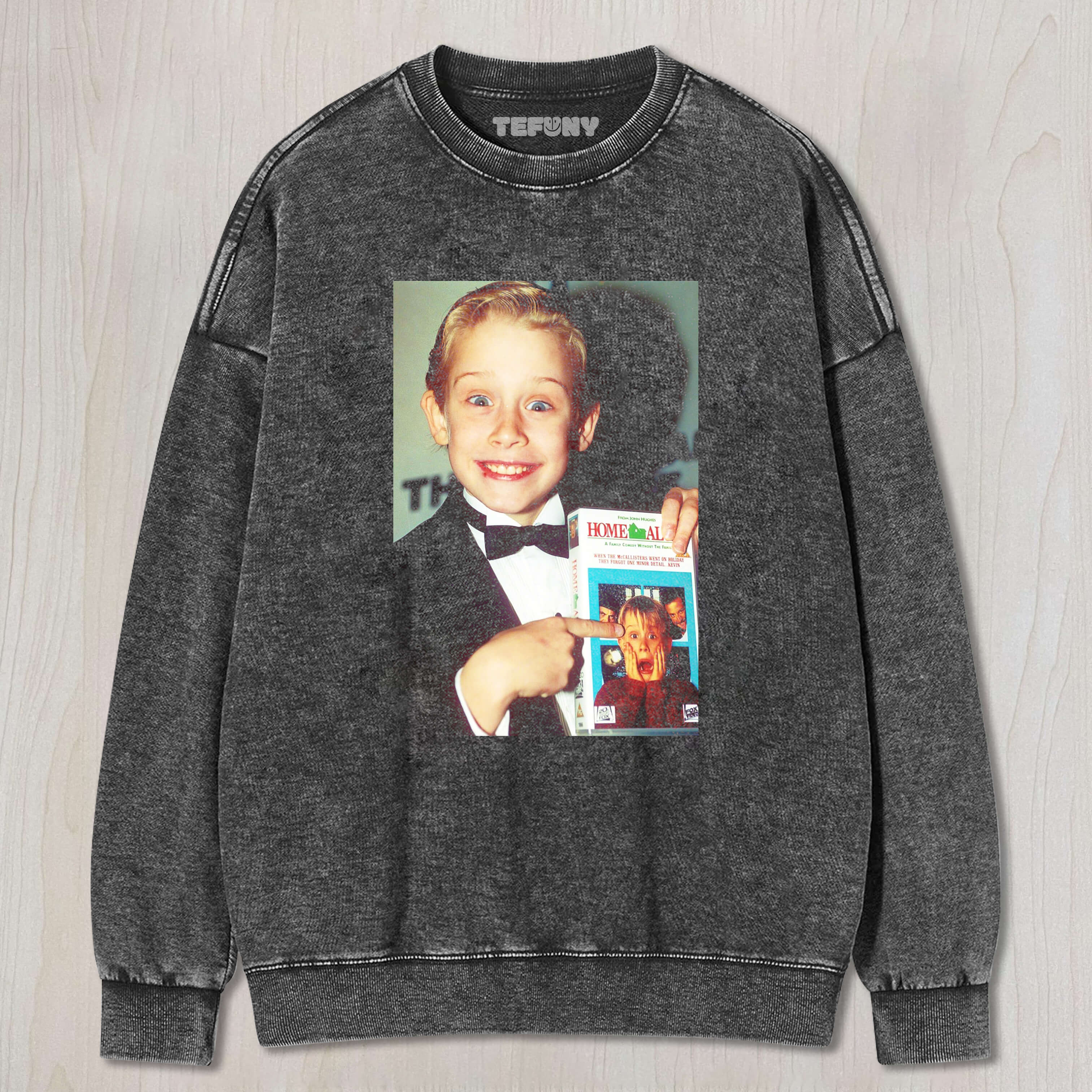 MACAULAY CULKIN IS HOLDING THE BOOK HOME ALONE T-SHIRT & LONG SLEEVES & HOODIES