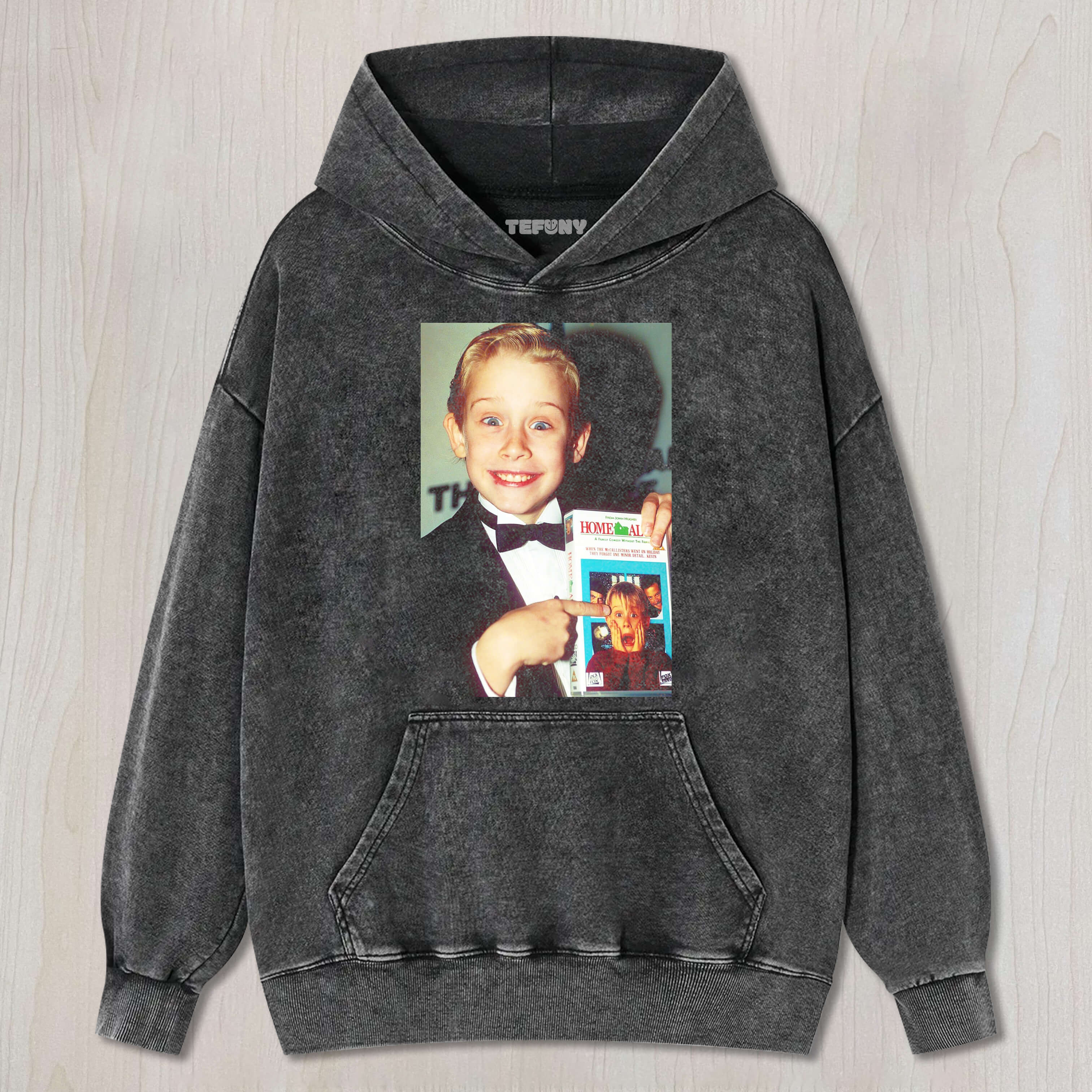 MACAULAY CULKIN IS HOLDING THE BOOK HOME ALONE T-SHIRT & LONG SLEEVES & HOODIES