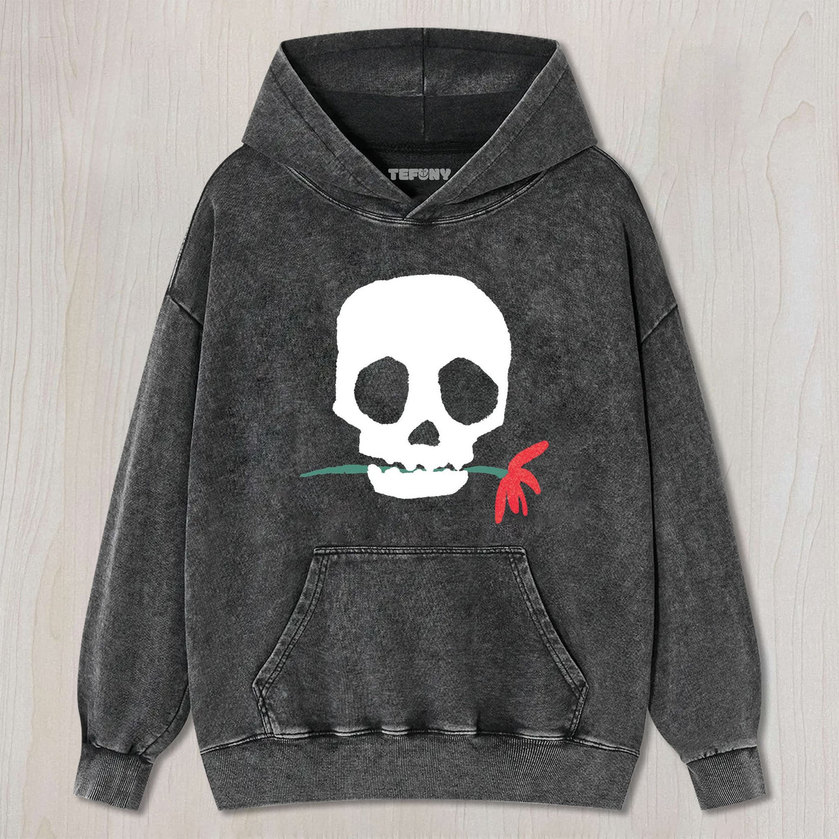 THE SKULL BITING A FLOWER UNISEX TEE, TANK TOP, LAYERED LS, SWEATSHIRT & HOODIE