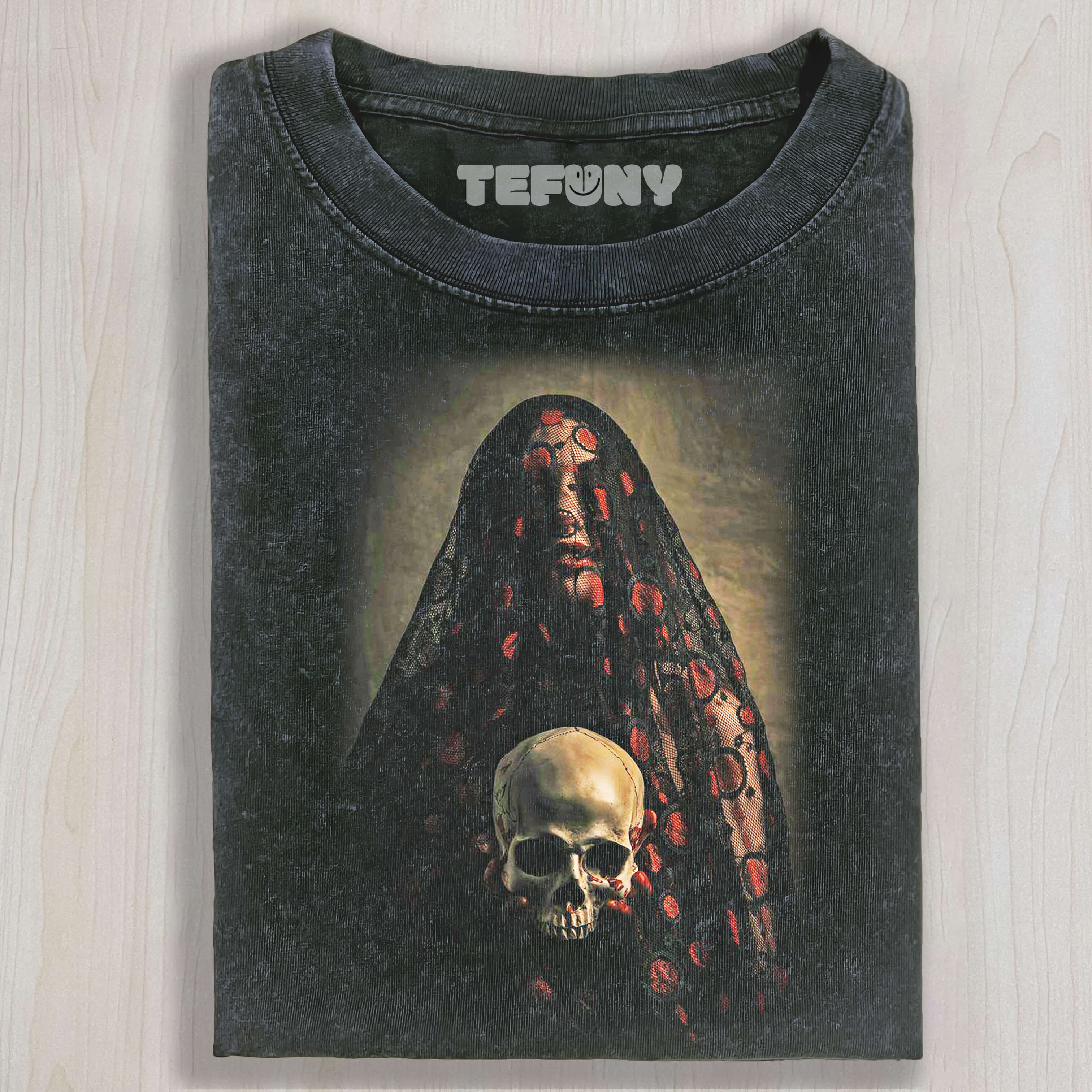 THE BRIDE, VEILED IN LACE, IS HOLDING A SKULL T-SHIRT