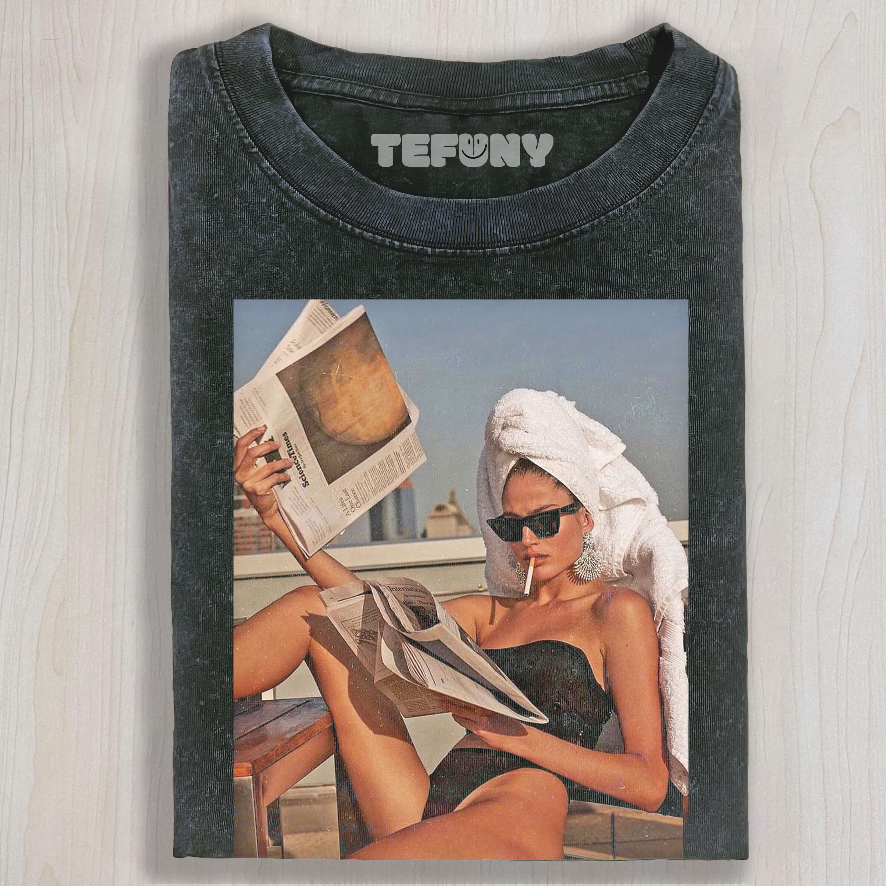 A BEAUTIFUL WOMAN READS A NEWSPAPER WHILE SUNBATHING T-SHIRT