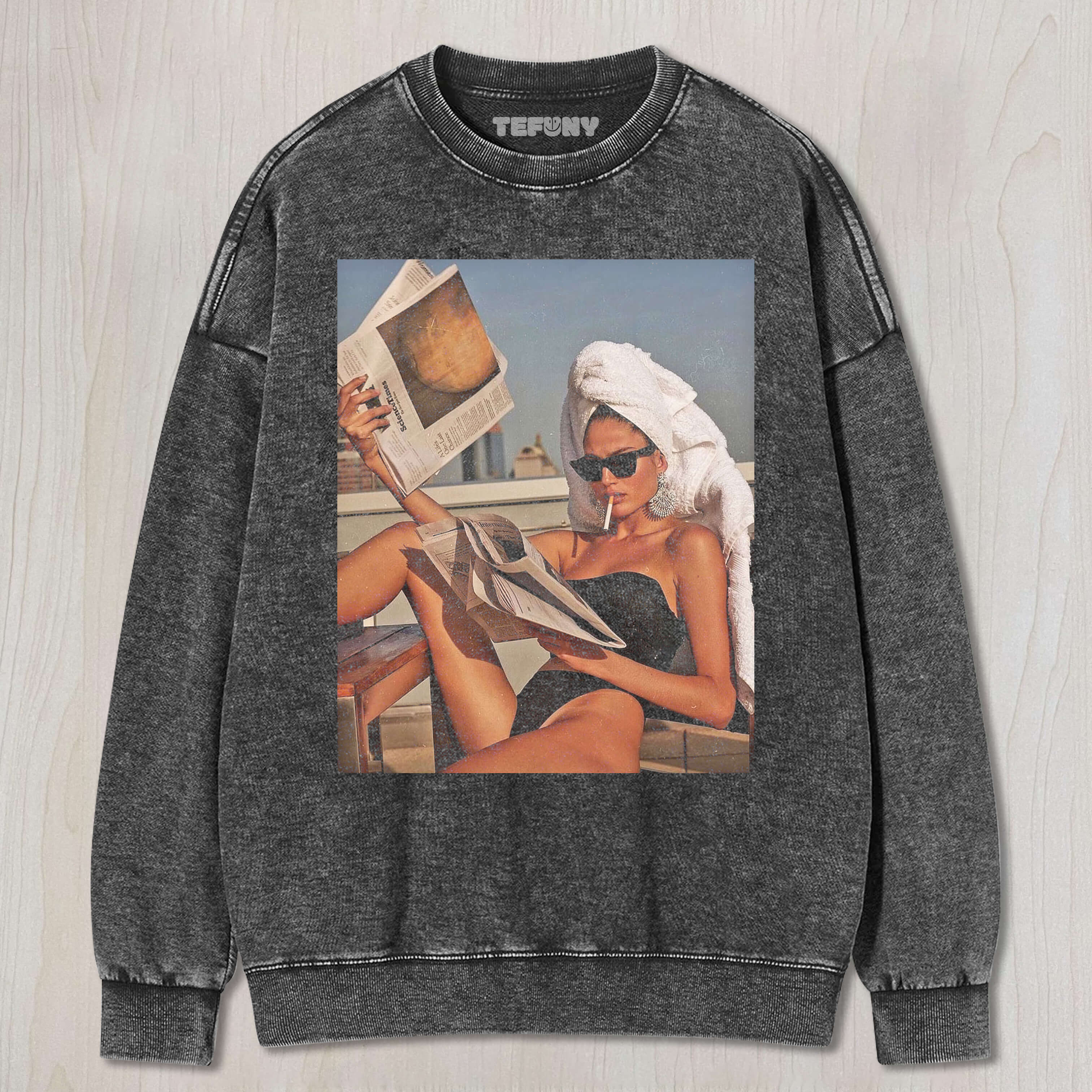 A BEAUTIFUL WOMAN READS A NEWSPAPER WHILE SUNBATHING T-SHIRT