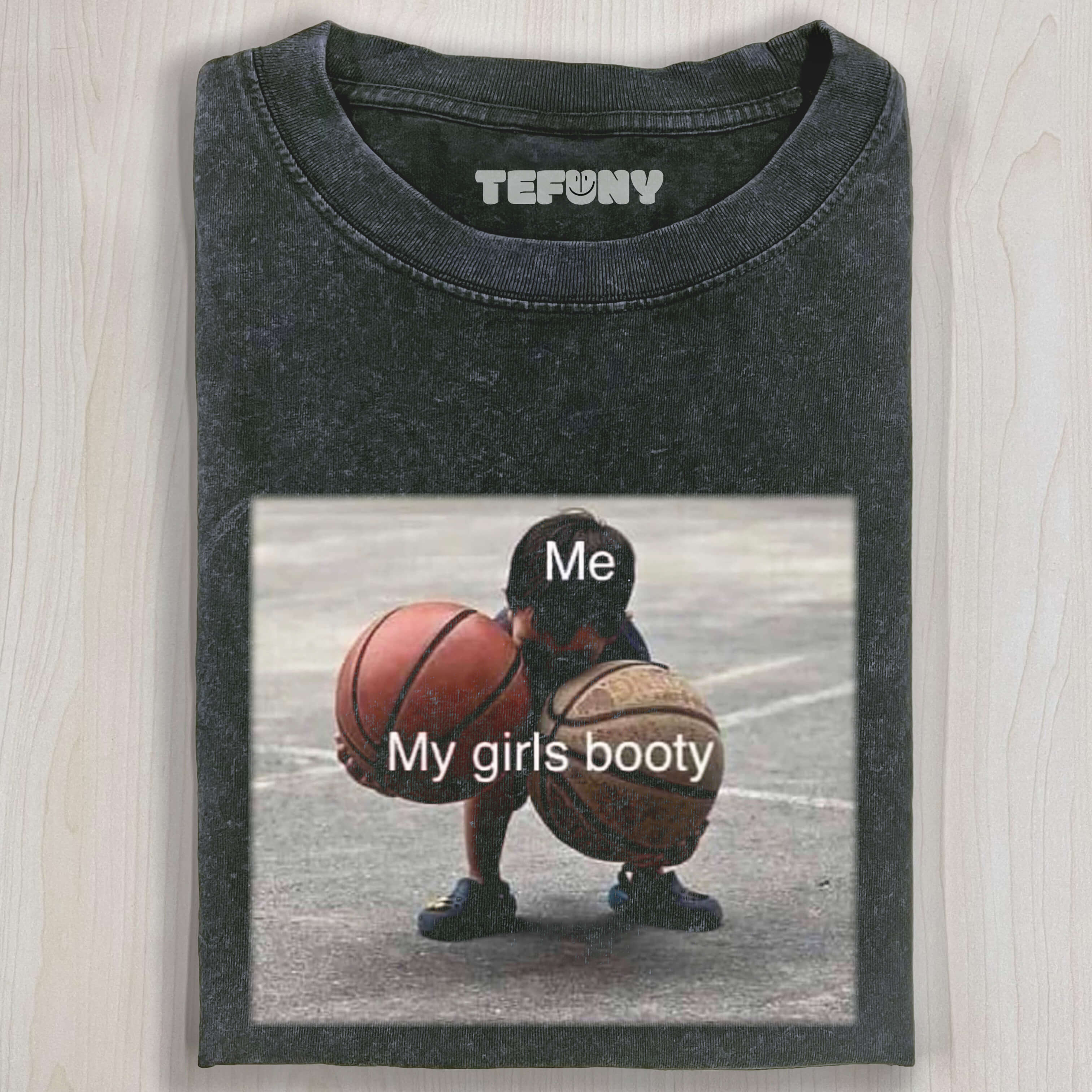 CHILD HOLDING TWO BALLS T-SHIRT