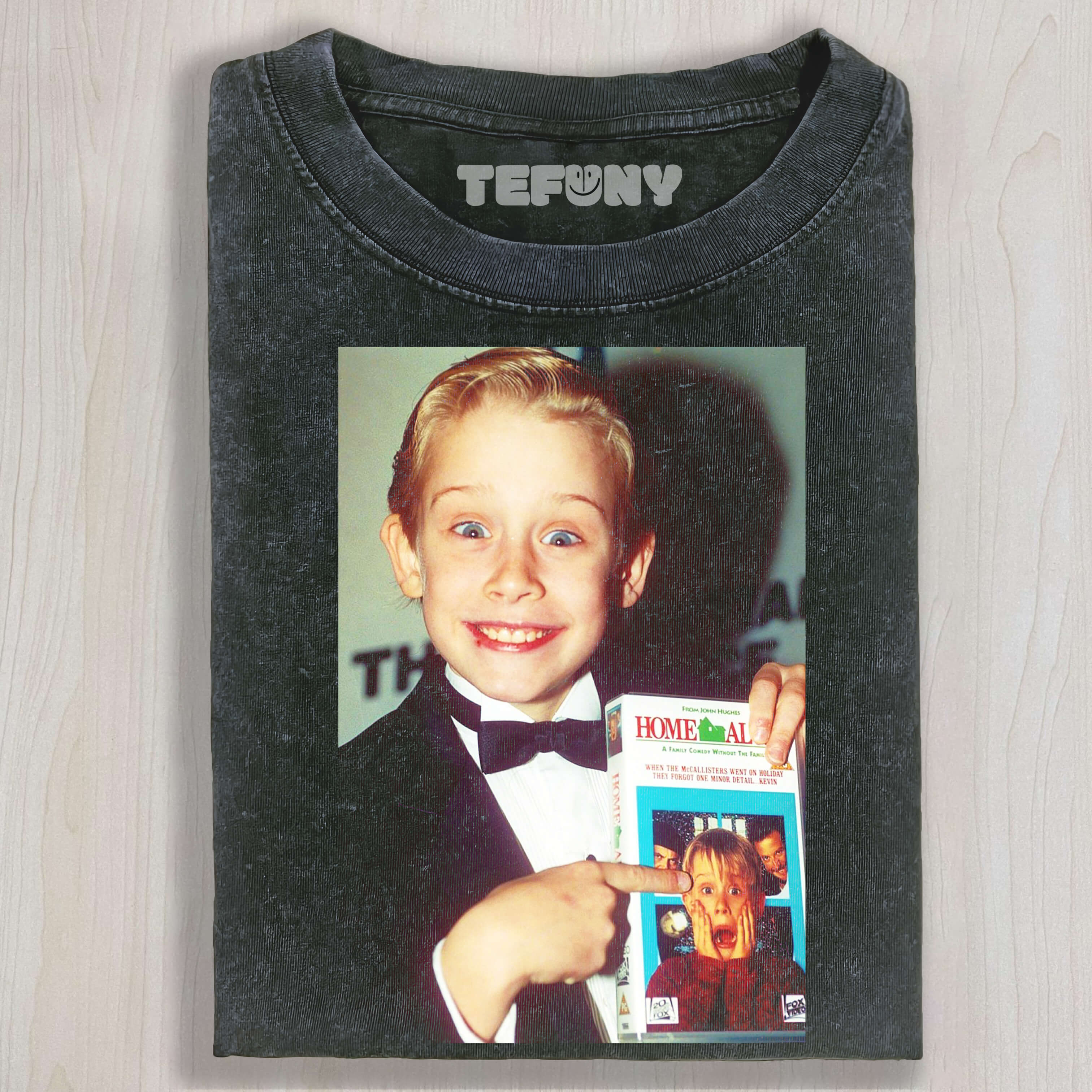 MACAULAY CULKIN IS HOLDING THE BOOK HOME ALONE T-SHIRT & LONG SLEEVES & HOODIES