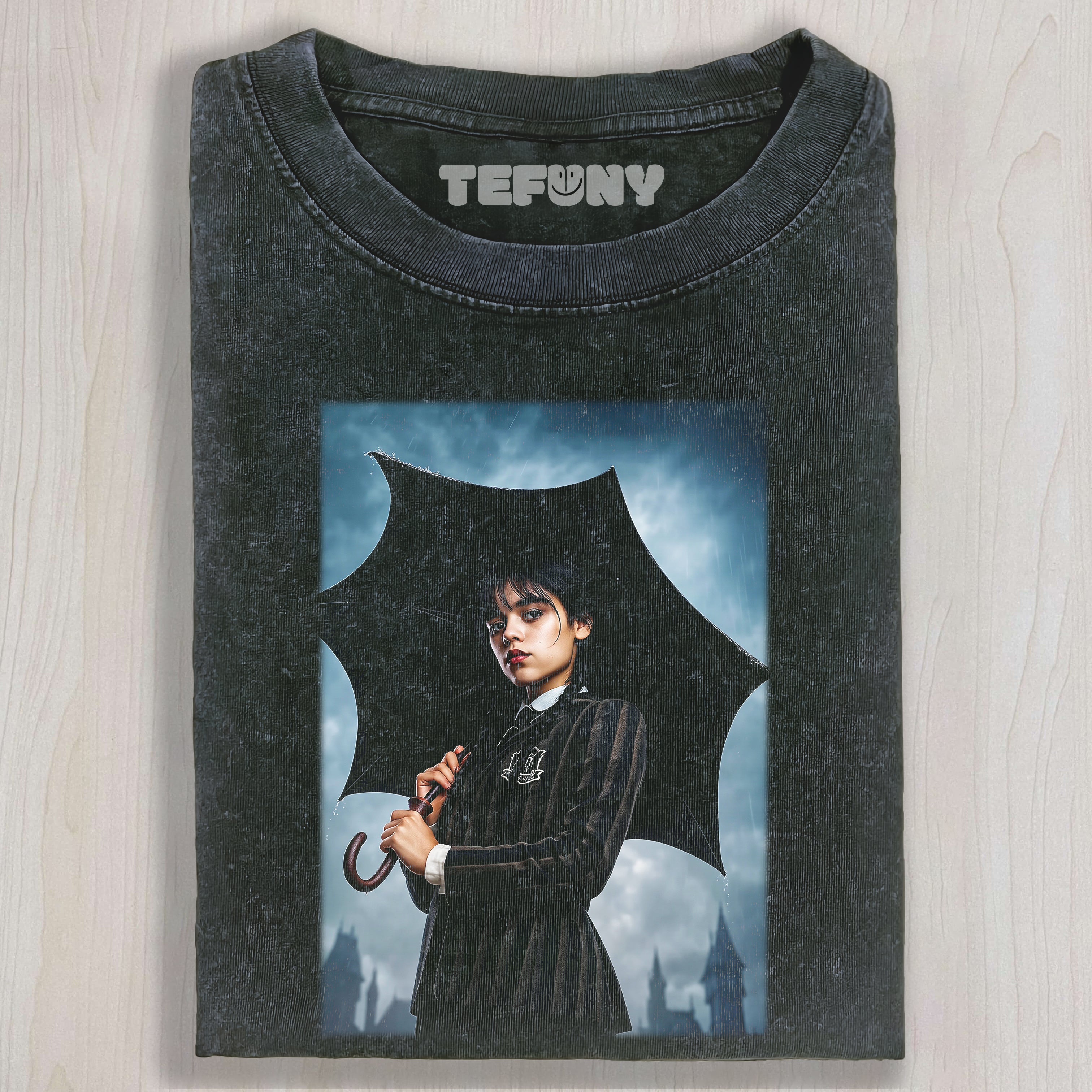 WEDNESDAY_ADDAMS_HOLDING_AN_UMBRELLA_T-SHIRT