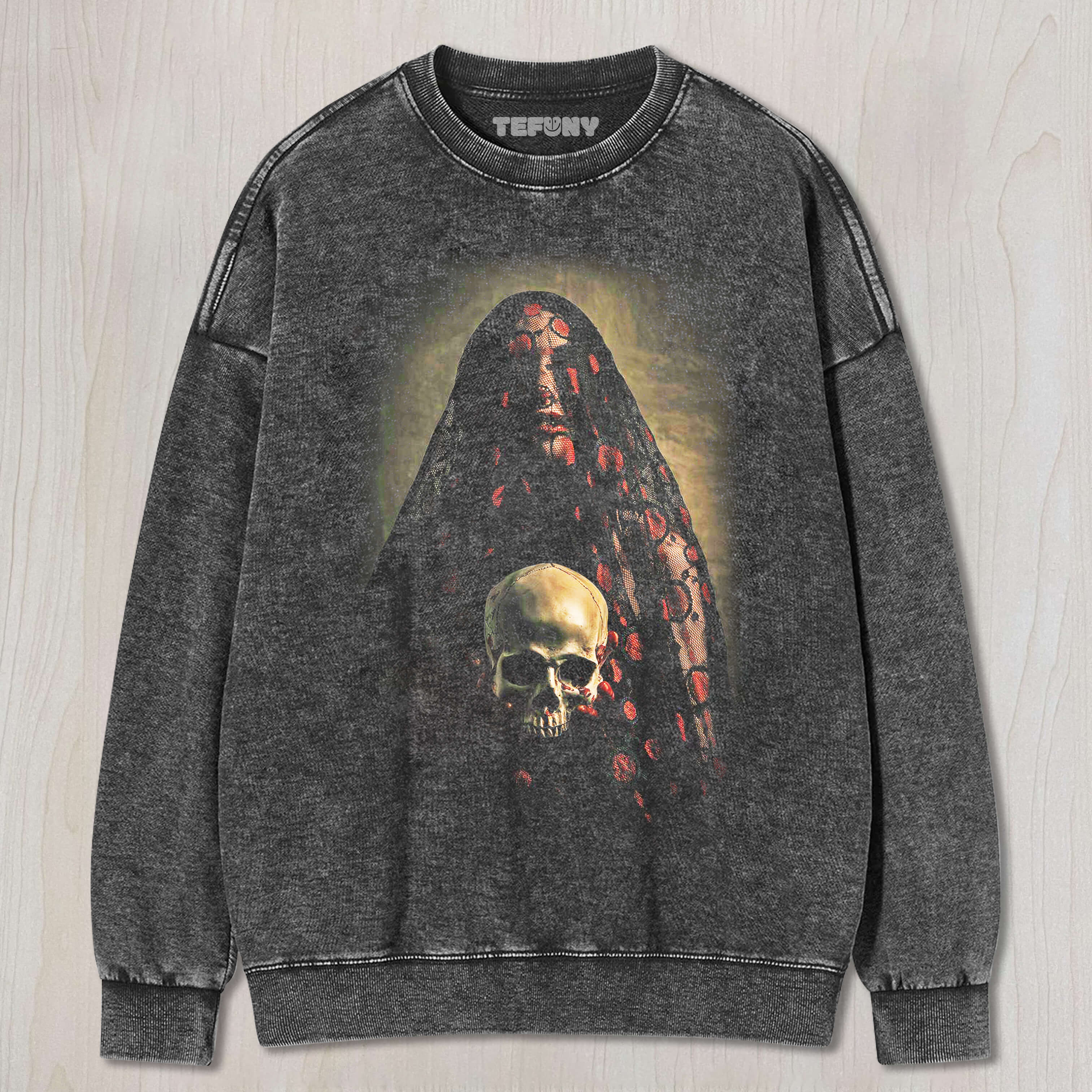 THE BRIDE, VEILED IN LACE, IS HOLDING A SKULL T-SHIRT