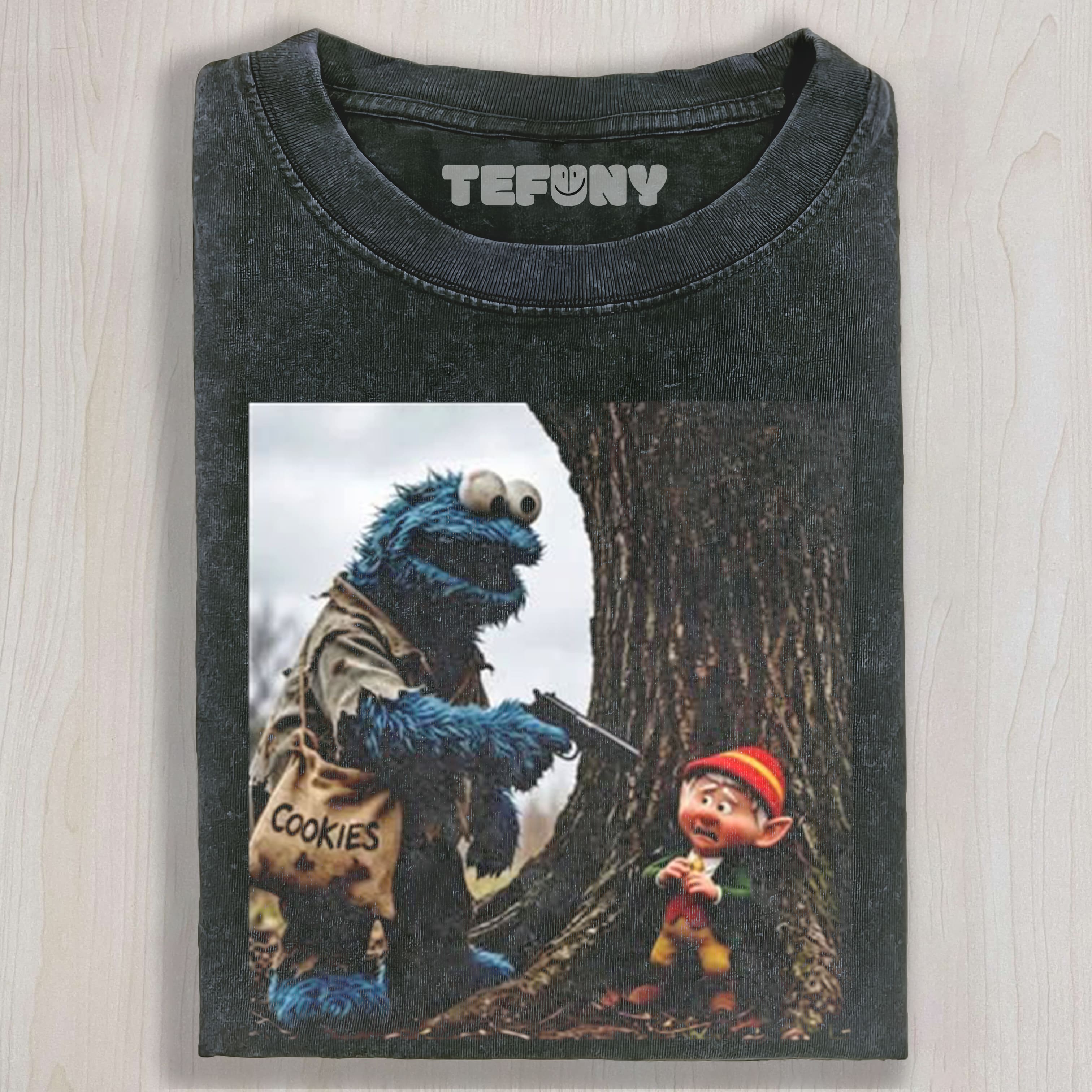 THE COOKIE MONSTER POINTS A GUN AT THE ELF UNISEX TEE, TANK TOP, LAYERED LS, SWEATSHIRT & HOODIE
