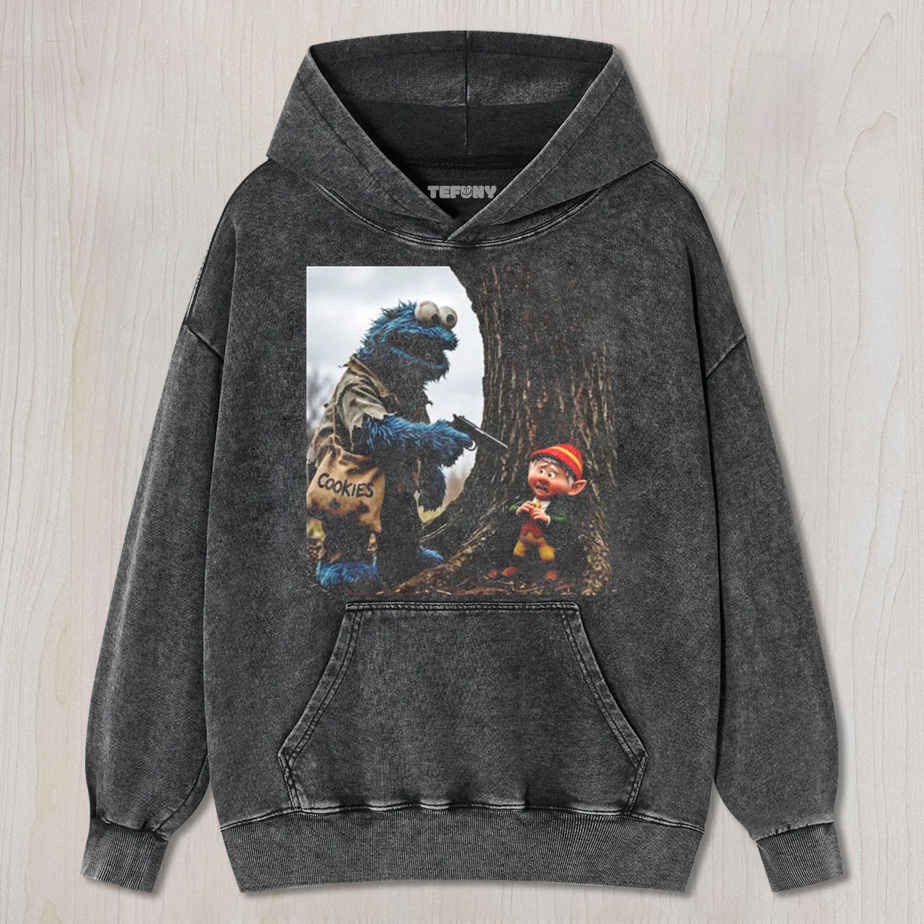 THE COOKIE MONSTER POINTS A GUN AT THE ELF UNISEX TEE, TANK TOP, LAYERED LS, SWEATSHIRT & HOODIE