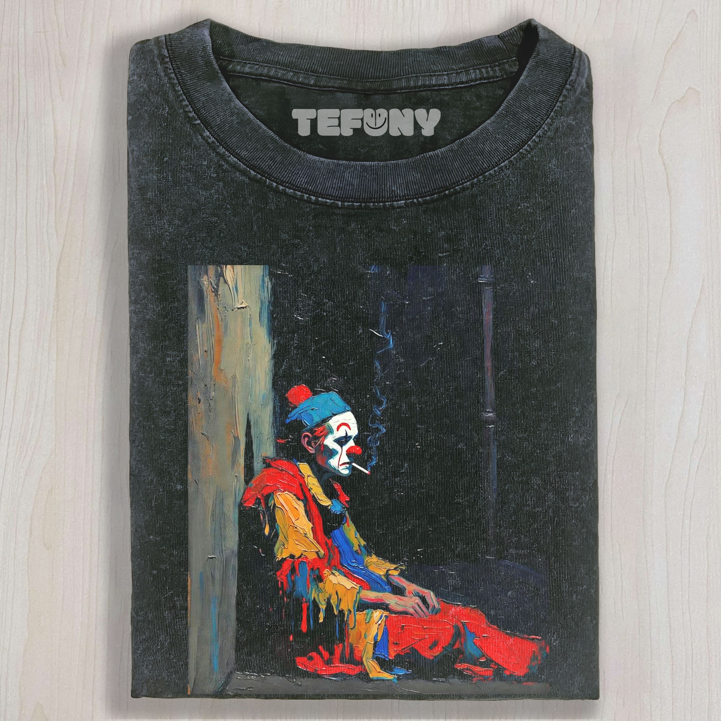 THE MELANCHOLY CLOWN IS SMOKING UNISEX TEE, TANK TOP, LAYERED LS, SWEATSHIRT & HOODIE