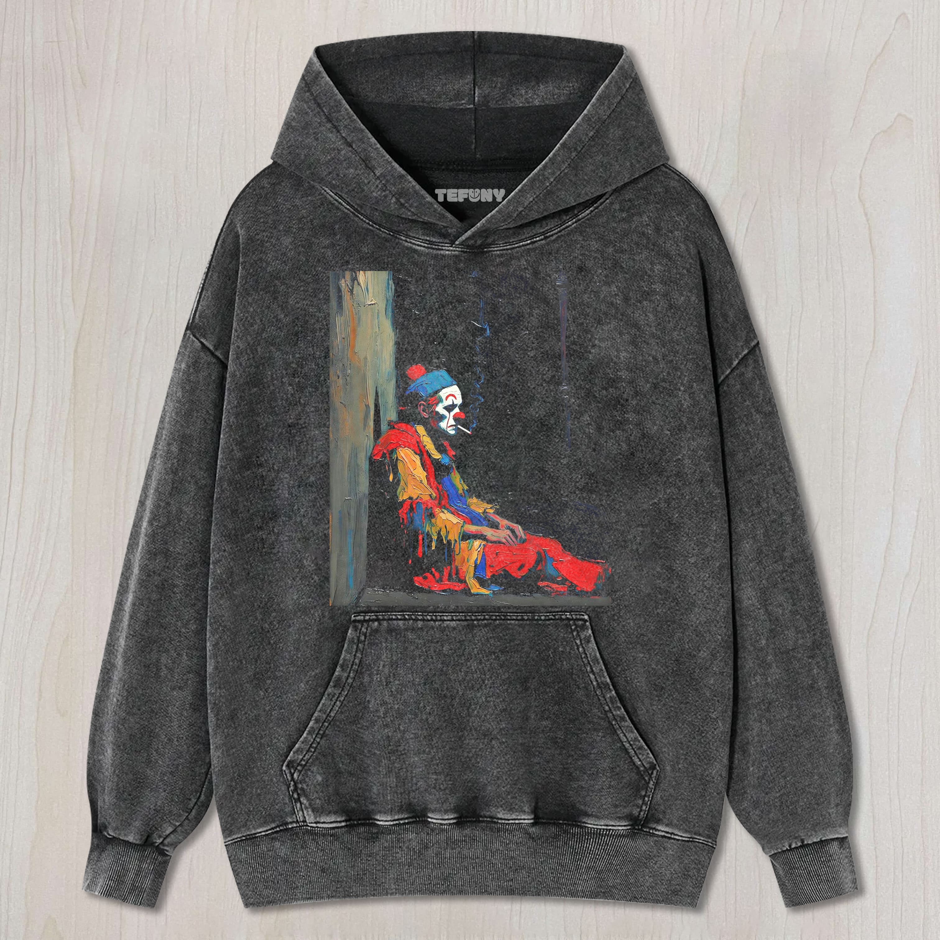 THE MELANCHOLY CLOWN IS SMOKING UNISEX TEE, TANK TOP, LAYERED LS, SWEATSHIRT & HOODIE