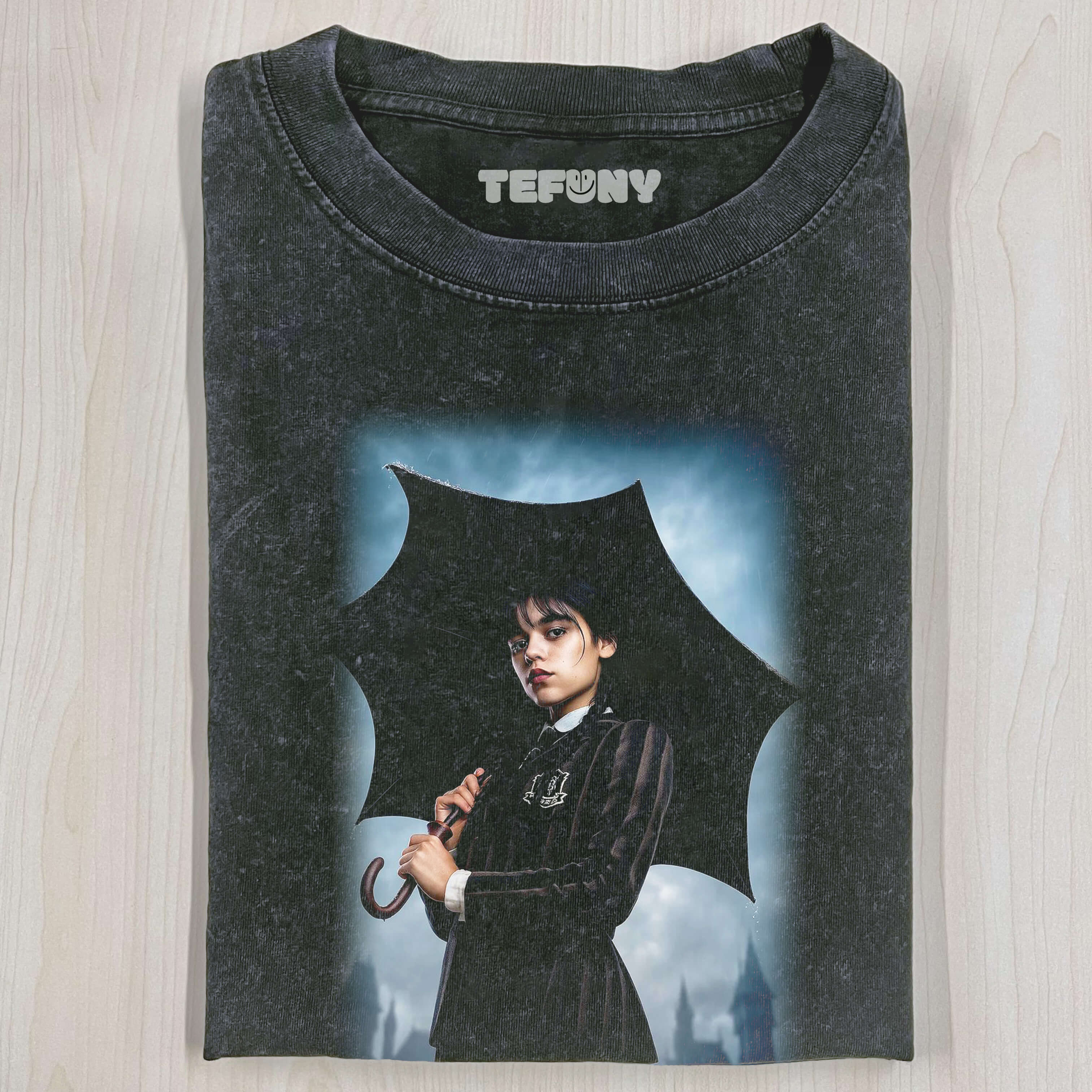 WEDNESDAY_ADDAMS_HOLDING_AN_UMBRELLA_T-SHIRT